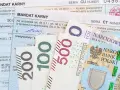 Mandaty karne i polskie banknoty 100, 200, 500 zł. Jak zapłacić mandat mBank? Dokumenty i pieniądze na stole.